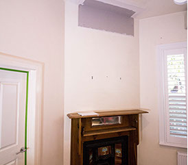 A corner fireplace in a small room