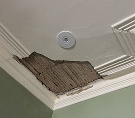 Old lath and plaster ceiling has fallen away from water damage