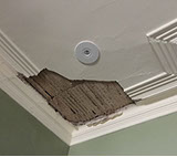 Old lath and plaster ceiling has fallen away from water damage